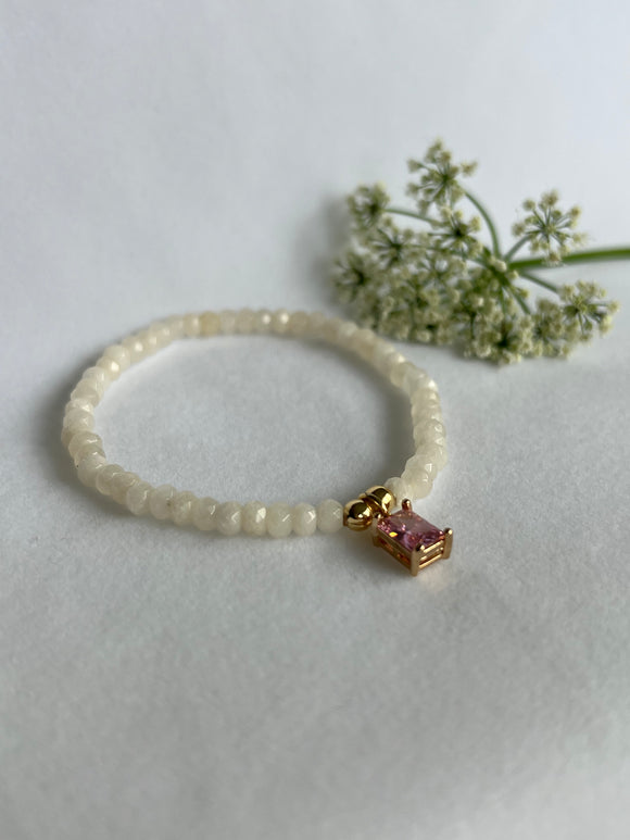 Armbånd Citrine fasettert og et gullfarget charms med rosa Cubic Zirkon