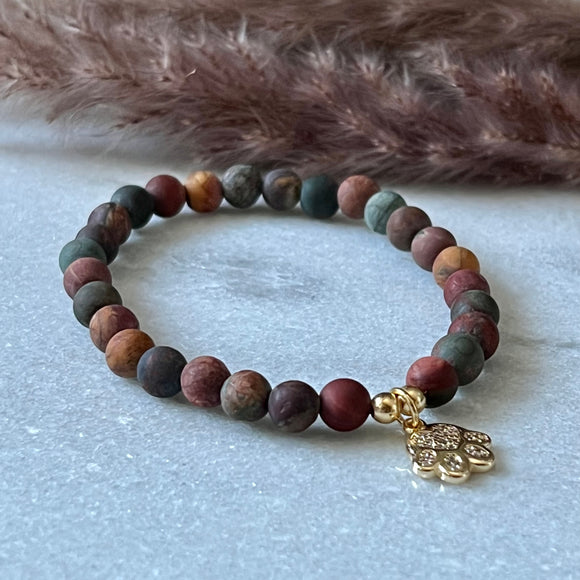 Armbånd Red Picture Jasper  med et gullfarget pote charms